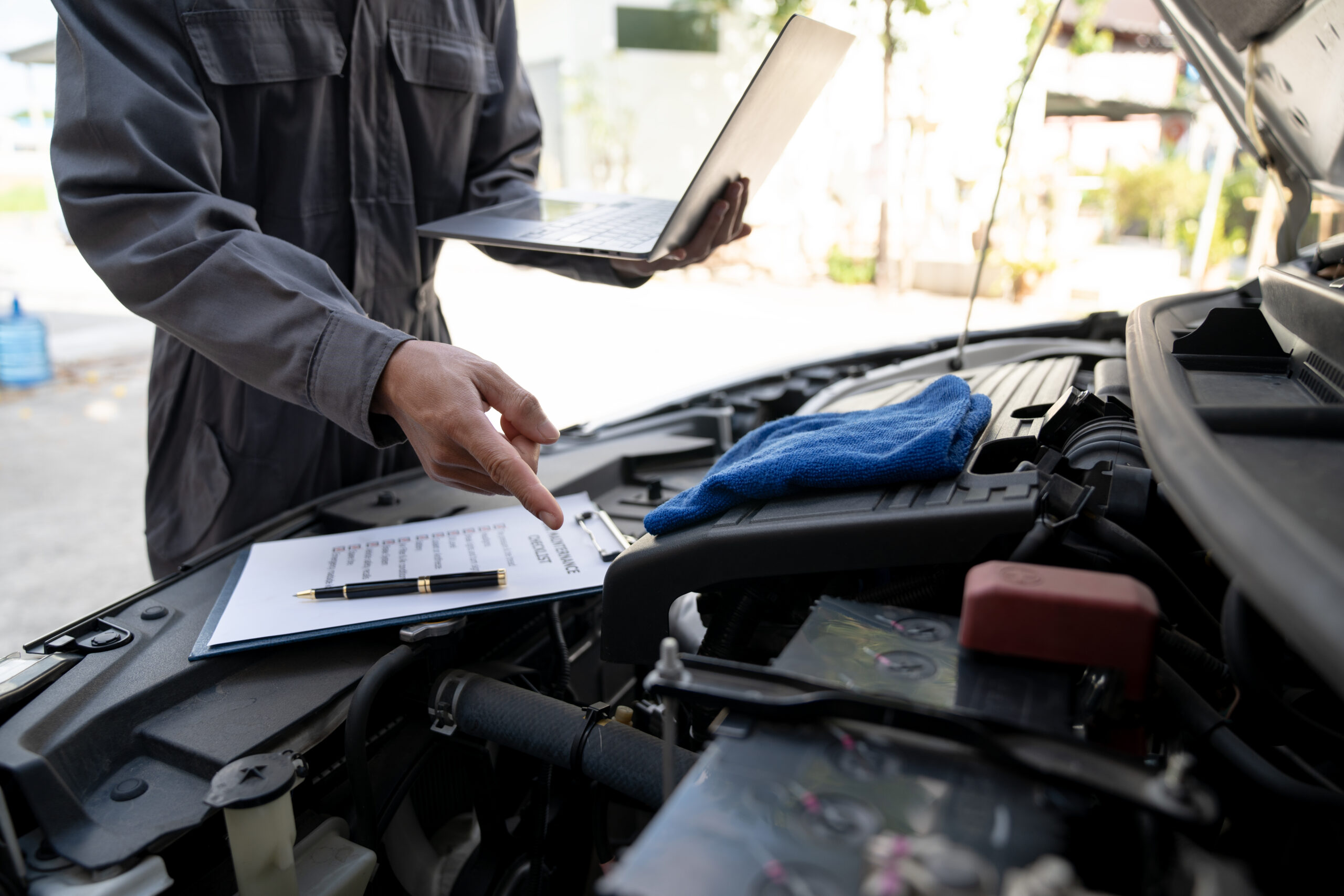 Maintenance engineer or auto mechanic checking car database usag